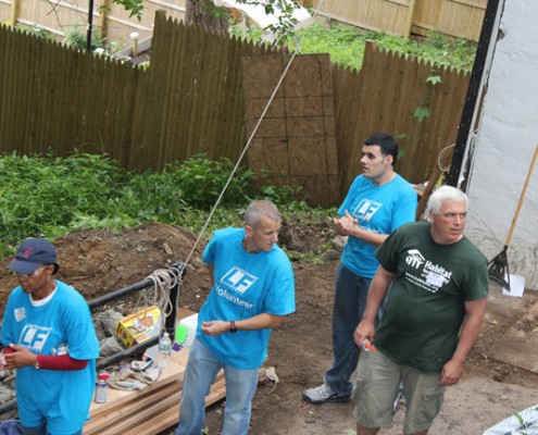 Men working on building house