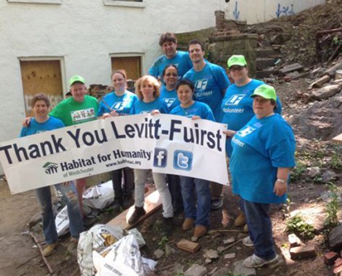 People holding sign which reads Thank you Levitt Fuirst