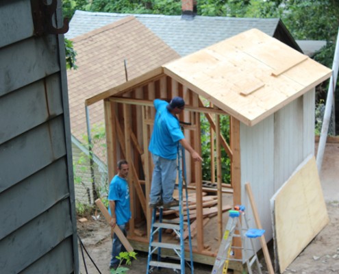 People working on building house