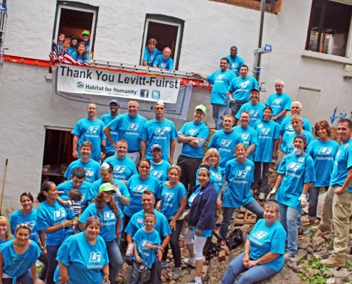 Group at Habitat for Humanity standing on rubble