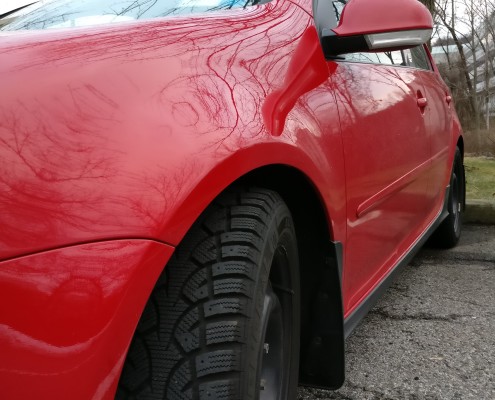 Snow tires on red car